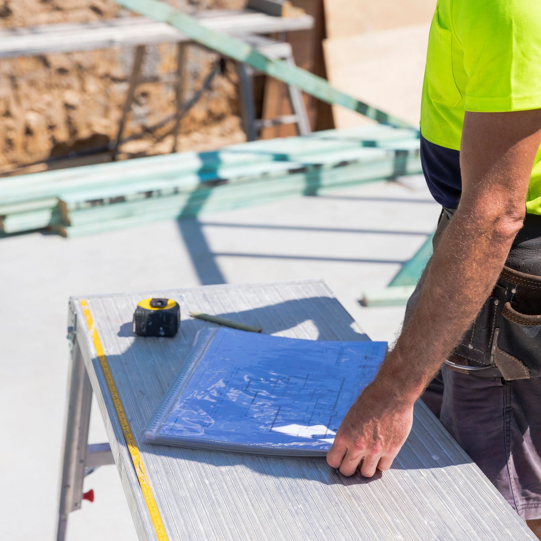 Construction worker reviewing blueprints