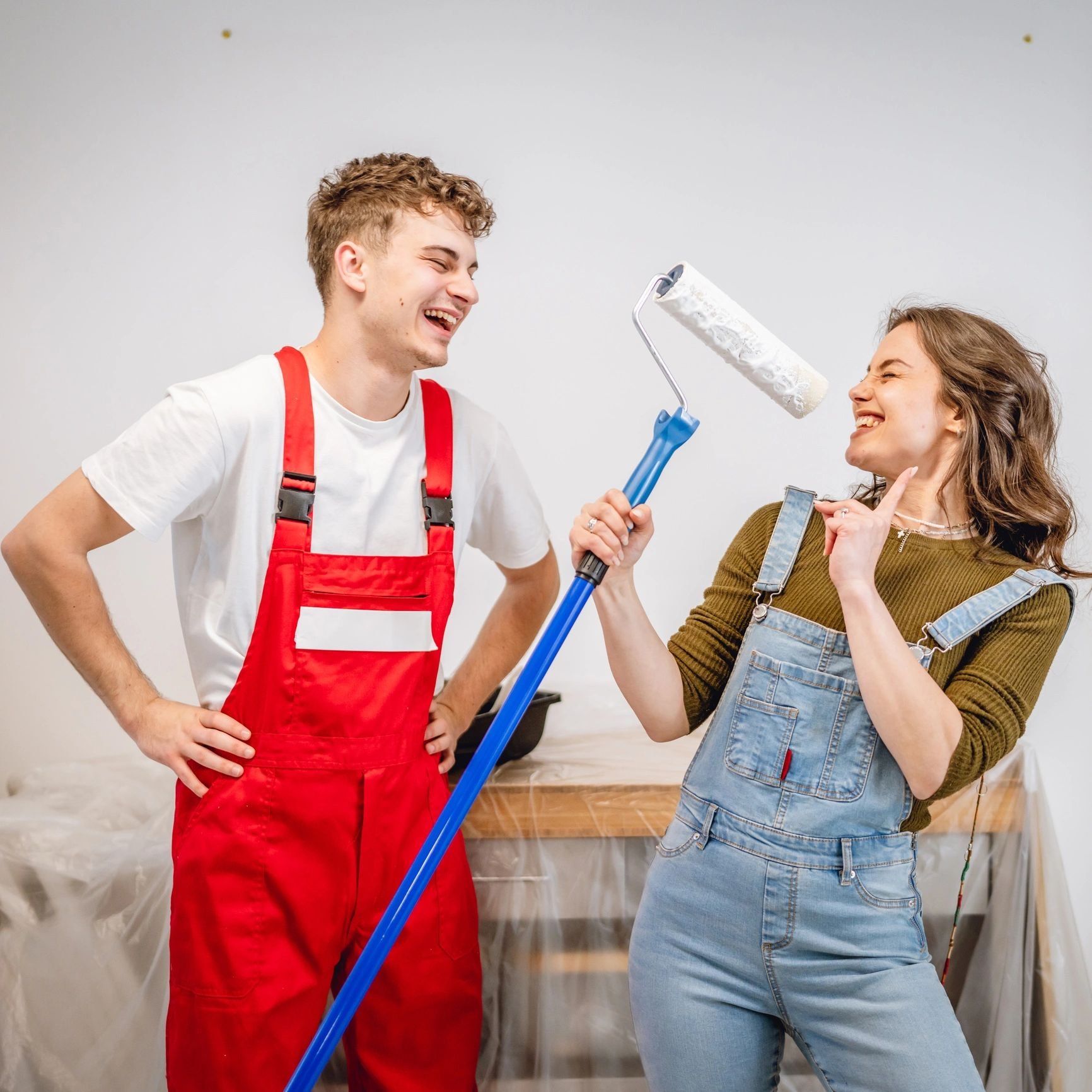 Two people painting during home renovation